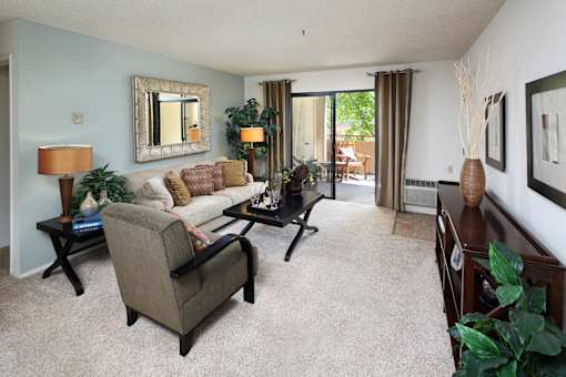 A living room with a grey couch and a coffee table. at The Maddox Sunnyvale Apartments, Sunnyvale, CA, 94087