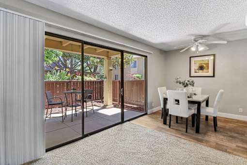 a dining room with sliding glass doors to a patio at Summerwood Apartments, Santa Clara, CA 95050
