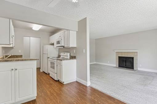 a view of a kitchen and a living room with a fireplace at Summerwood Apartments, California, 95050