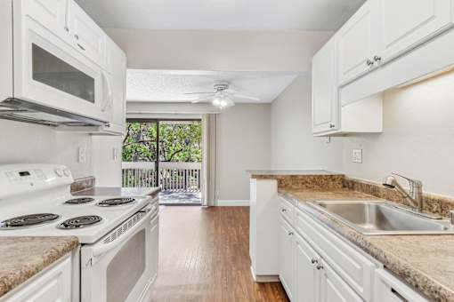 a room filled with many giraffes in a white room at Summerwood Apartments, Santa Clara, 95050