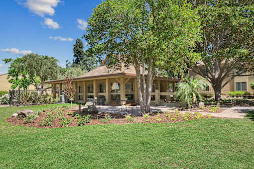 a view of a house with trees and grass at Summerwood Apartments, Santa Clara, CA