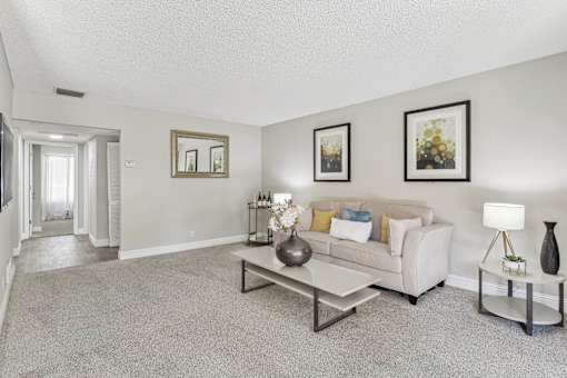 a living room with a couch and a coffee table at Summerwood Apartments, California, 95050