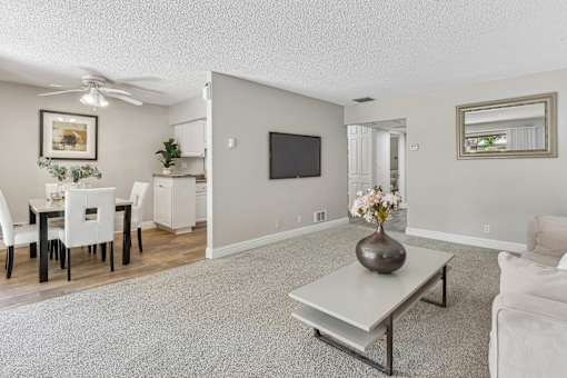 a living room with a couch and a table at Summerwood Apartments, Santa Clara, CA