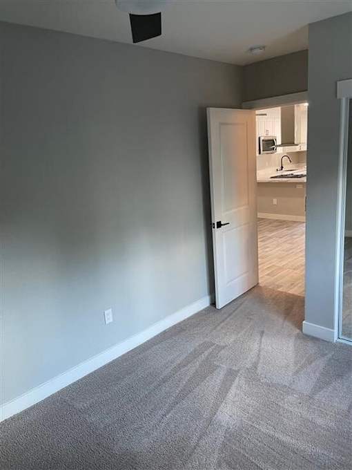 an empty living room with a door to a kitchen at Danville Park, Danville, CA