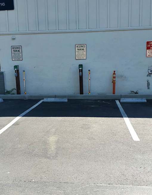 a blue building with parking meters in a parking lot at Danville Park, Danville, CA