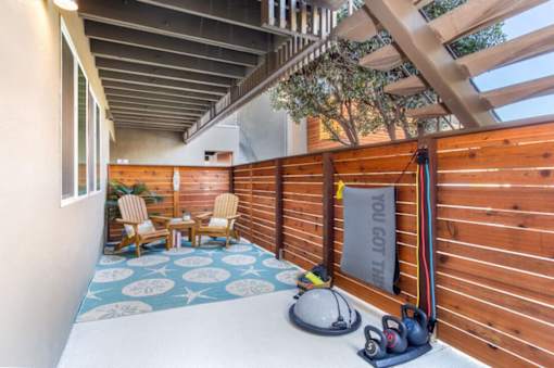 a patio with a wooden fence and a pair of shoes on the floor at Element LLC, Sunnyvale, CA