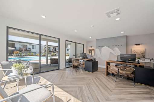 A modern office space with a pool visible through the glass doors at Latitude Apartments at Mission Valley Apartments, San Diego, 92120