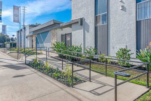 a building with stairs and plants in front of itat BLVD Apartments LLC, California