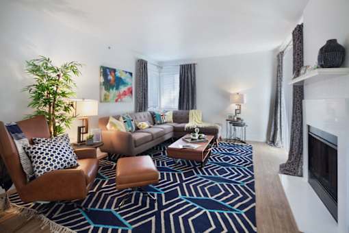 a living room with a couch and a fireplace at The Bryant, Yorba Linda California