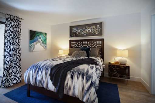 a bedroom with a bed and a blue rug at The Bryant, Yorba Linda, CA