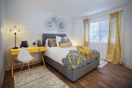 a bedroom with a bed and a desk at The Bryant, Yorba Linda