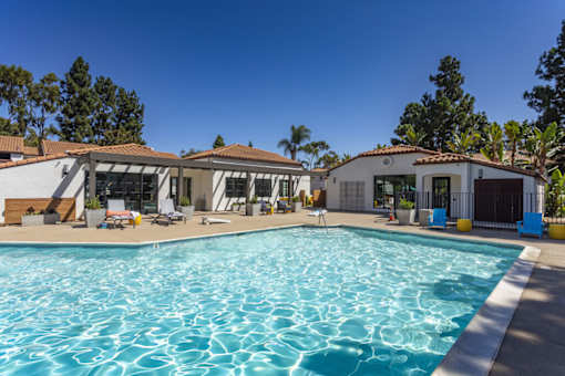 a swimming pool with a house in the background at La Jolla Blue, San Diego, CA 92122