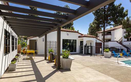 a patio with a white building and a swimming pool at La Jolla Blue, California