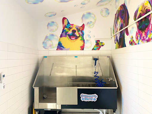 a large painting of a dog on the wall above a hot dog at La Jolla Blue, San Diego California