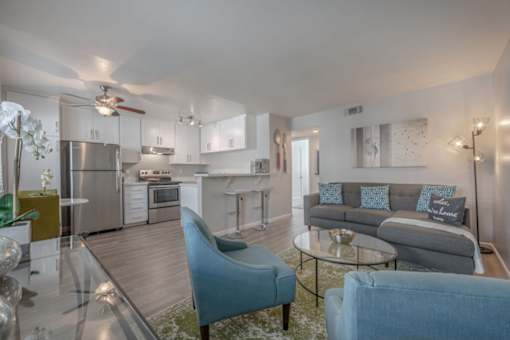 a living room with couches and chairs and a kitchen with stainless steel appliances at Napa Green Apartments LLC, Napa, 94559