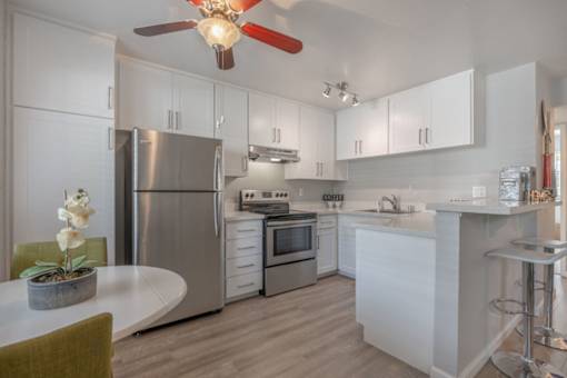 a kitchen with blue and red lights on the ceiling and white counters at Napa Green Apartments LLC, California, 94559