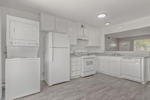 Kitchen with white appliances at Ocean Villas Apartments, California