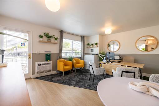 A modern office space with a desk, chairs, and a computer.at Summerhill Place Apartments, California