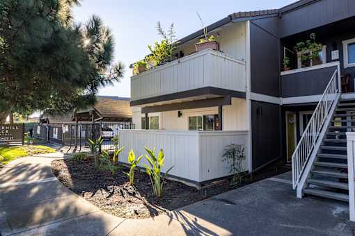 A modern two-story house with a balcony on the second floor.at Summerhill Place Apartments, Union City California