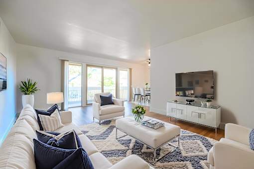A living room with white furniture and a flat screen TV at Summerwood Apartment, Santa Clara, CA, 95050