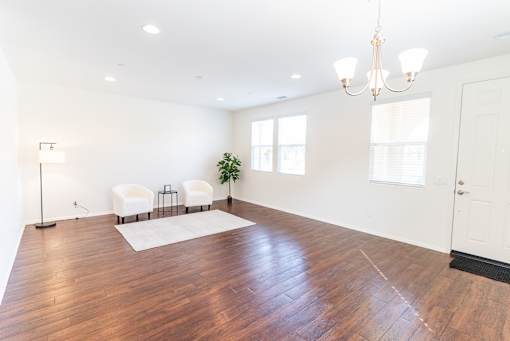 a living room with a hard wood floor and white walls at The Vines at Riverpark, LLC, California, 93036