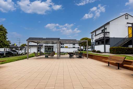 Patio with benches and a table at The Gates at the Marina Apartments, Marina, CA, 93933