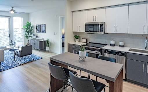 A modern kitchen with a dining table and chairs.