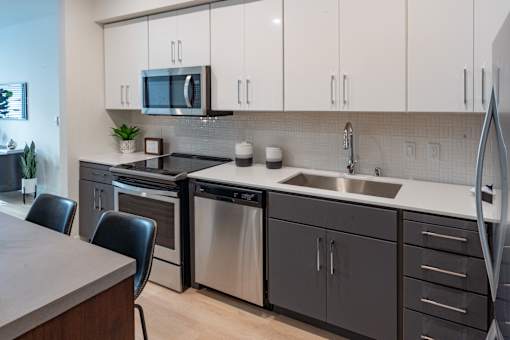 A modern kitchen with a dining table and chairs.