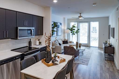 A modern kitchen with a dining table and chairs.