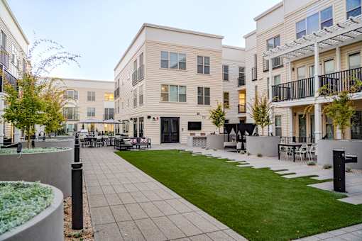 A modern courtyard surrounded by apartment buildings.