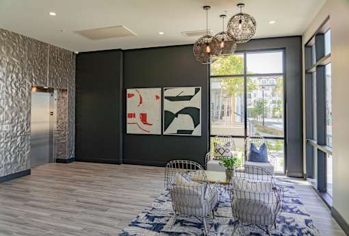 A modern living room with a large abstract painting on the wall.