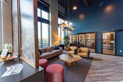 A modern living room with a sofa, armchairs, and a coffee table.