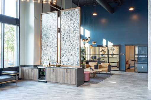 A room with a glass wall and a wooden floor.