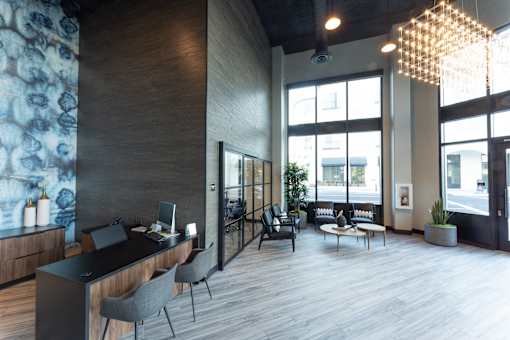 A modern office space with a reception desk and comfortable seating areas.