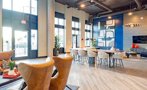 A modern dining area with a large table and chairs.