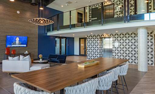 A modern dining room with a wooden table and chairs.