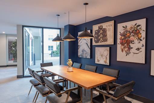 A dining room with a wooden table and chairs.