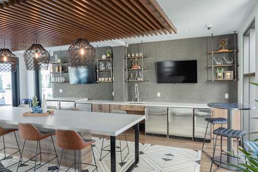A modern dining area with a long table and chairs.