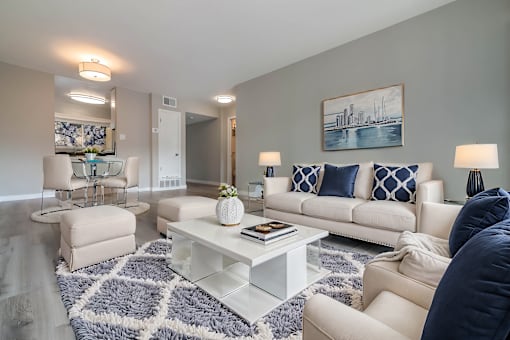 A living room with a white couch and a blue and white patterned rug at The Pier at Sausalito, Sausalito, CA