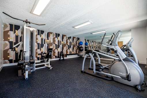 a gym with treadmills and other exercise equipment at Campbell West Apartments, Campbell