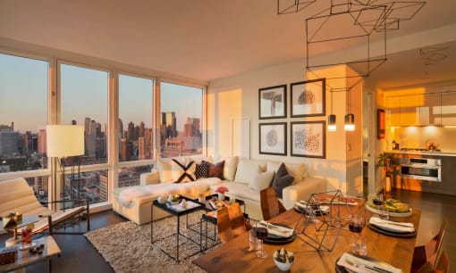 a living room filled with furniture and a large window at SKY Apartments, New York