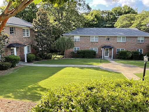a large brick house with a yard in front of it