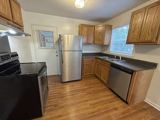 a kitchen with stainless steel appliances and wooden cabinets