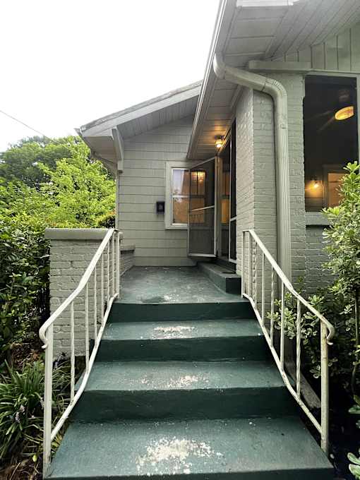 a view of the front of a house with stairs and a porch