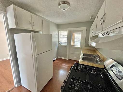 a kitchen with a stove and a refrigerator