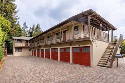 the carriage house has a large garage with red doors