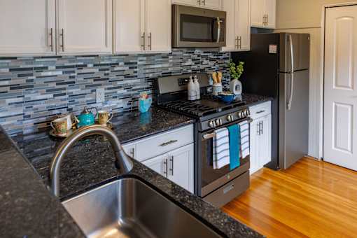 a kitchen with granite counter tops and stainless steel appliances