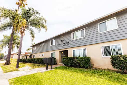 A building with the words "Royal Palm Apartments" on the front.