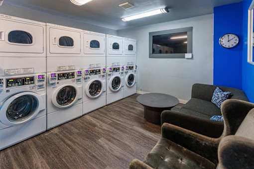 A row of washing machines in a laundromat.