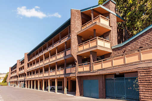 A large multi-story parking garage with a blue sky in the background.